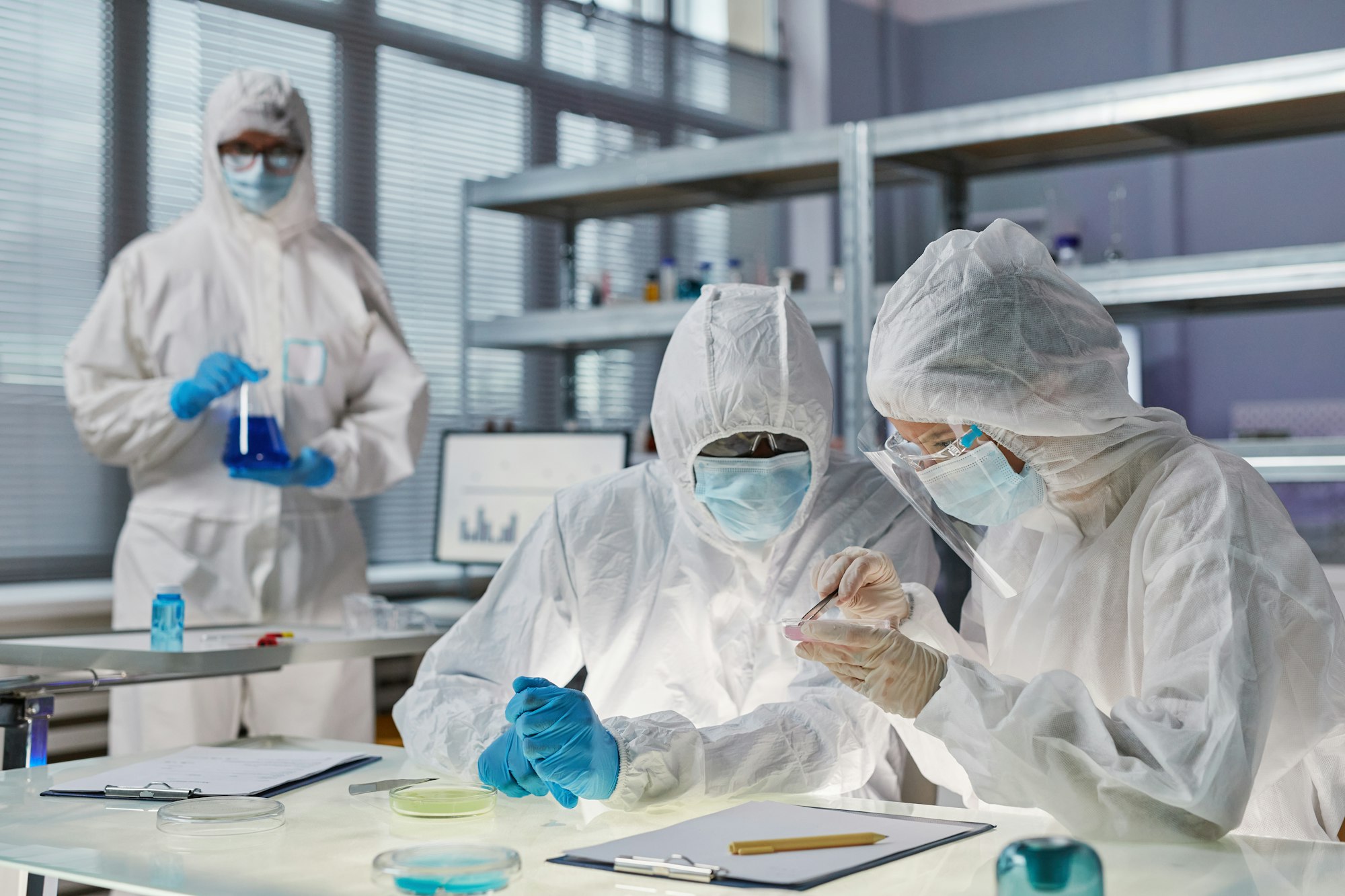 People in protective wear working in the laboratory