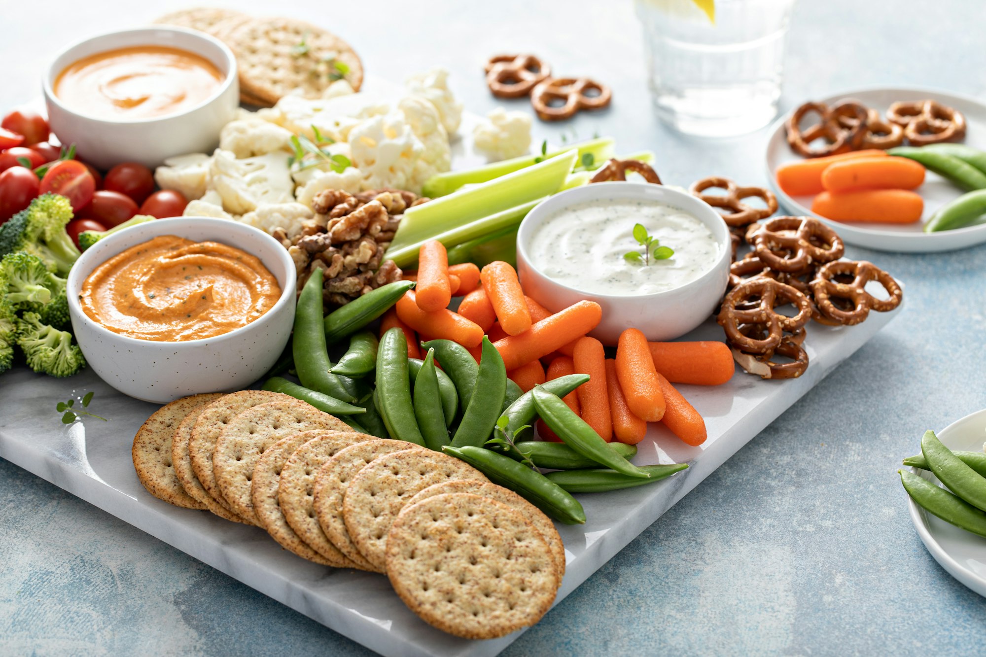 Plant based snack board with vegetables and crackers