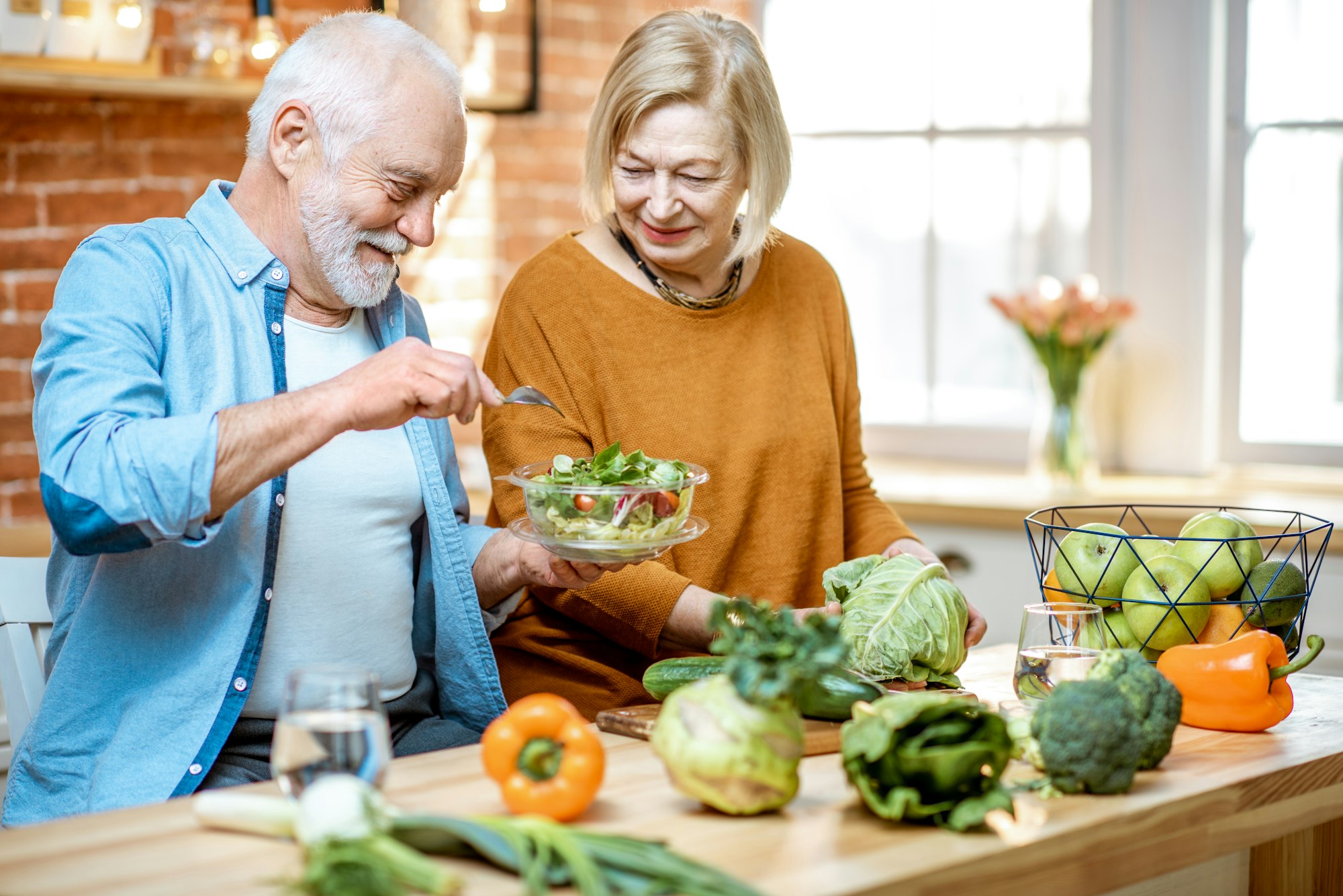 Senior couple with healthy food at home